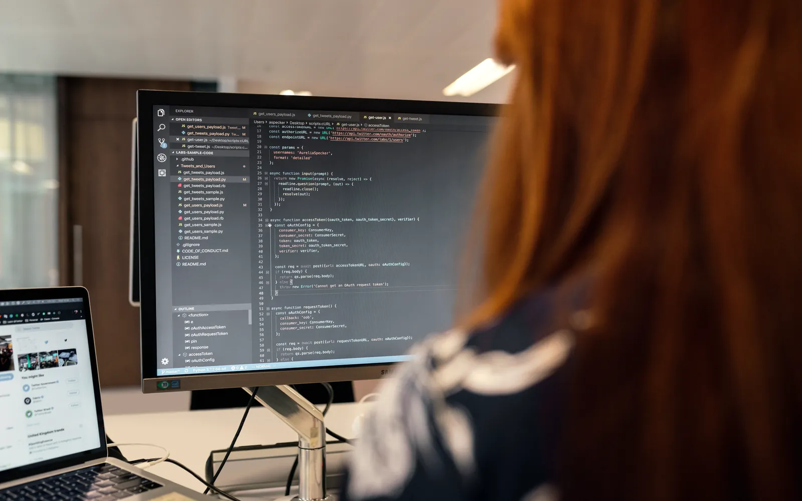 Persona desarrollando el código de una aplicación en un editor sobre un monitor externo